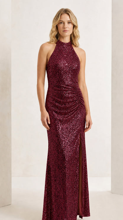 Front full-length view of model wearing the burgundy red halter sequin evening maxi gown