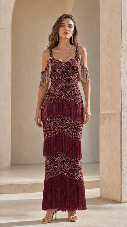 Front view of woman wearing burgundy wine beaded fringe maxi evening gown