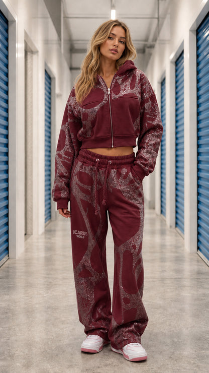 Front view of model wearing Burgundy glitter graphic cropped zip hoodie and wide leg sweatpants set