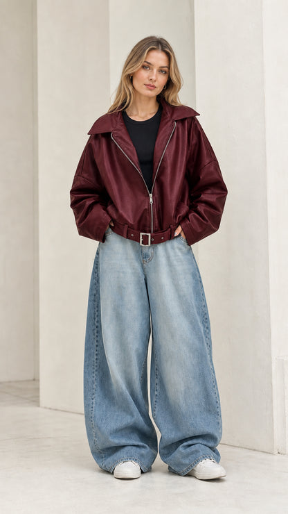 Full front view of model wearing burgundy red oversized faux leather jacket