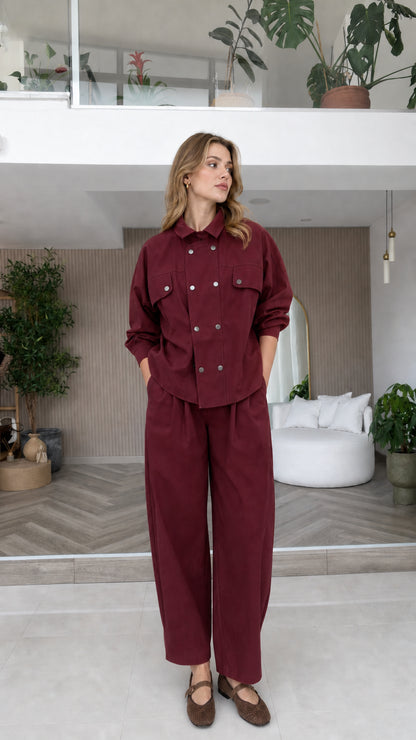 Model wearing burgundy double-breasted shirt and relaxed trousers two-piece set