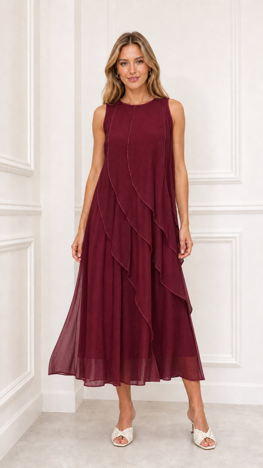 Model wearing burgundy sleeveless cascading ruffle midi dress