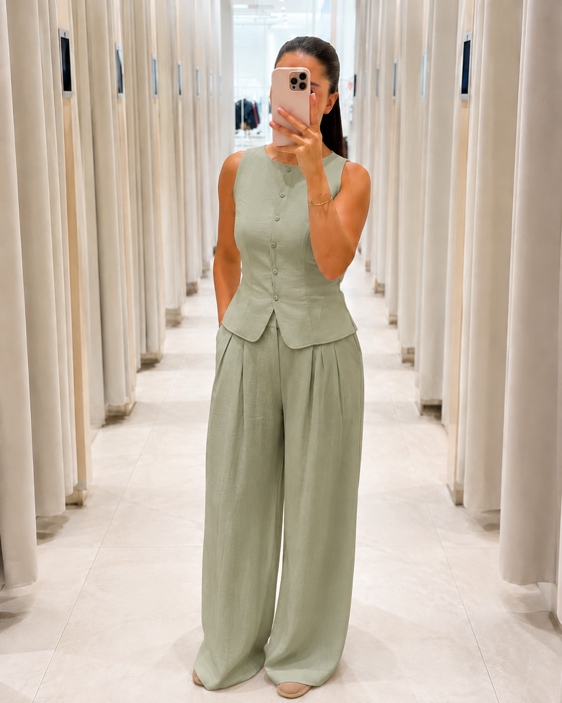 Front view of sage sleeveless peplum top and wide leg pants set