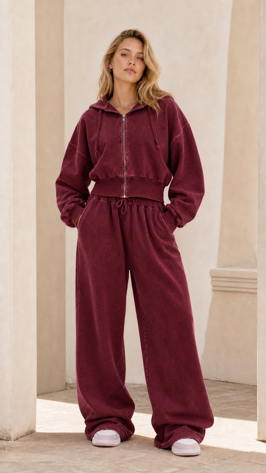 Full front view of model wearing burgundy cropped zip hoodie and wide leg sweatpants set