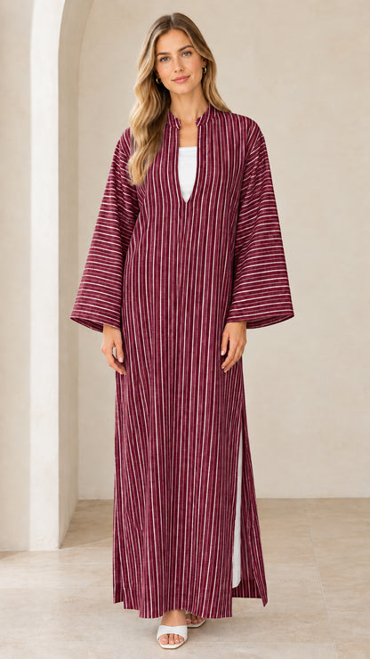Woman wearing burgundy vertical striped maxi kaftan dress