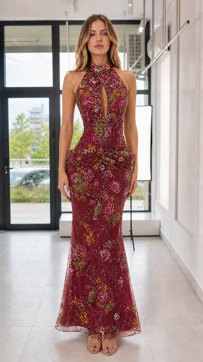 Model wearing burgundy floral sequin evening gown