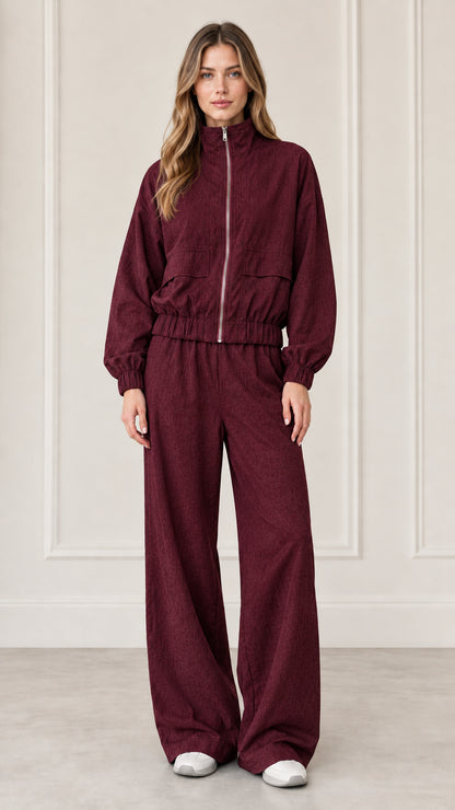 Front full-length view of woman wearing Burgundy zip-up jacket and wide-leg pants set
