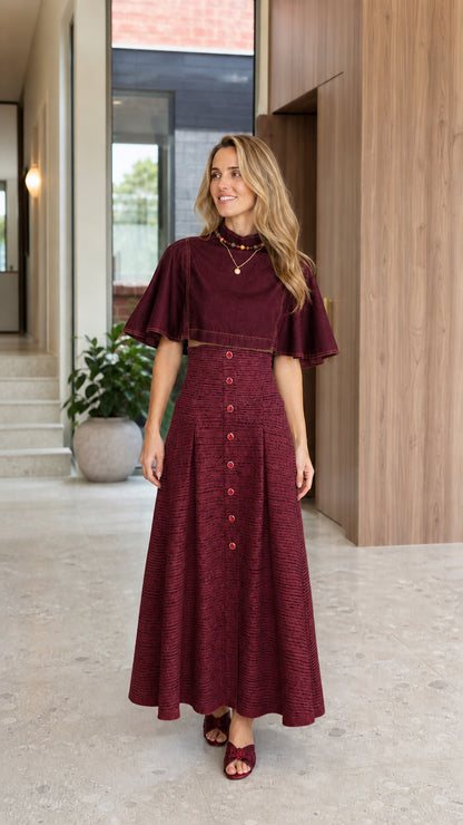 Full-length front view of woman wearing Burgundy wine red capelet mock neck pleated maxi dress