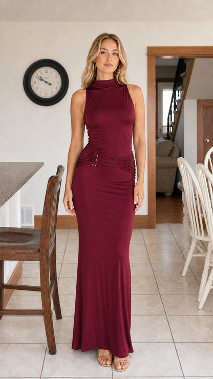Front full-length view of woman wearing burgundy wine sleeveless mock neck maxi dress