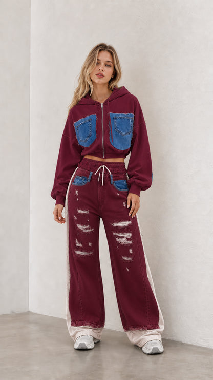 Model wearing burgundy cropped zip hoodie and matching spliced wide leg pants set