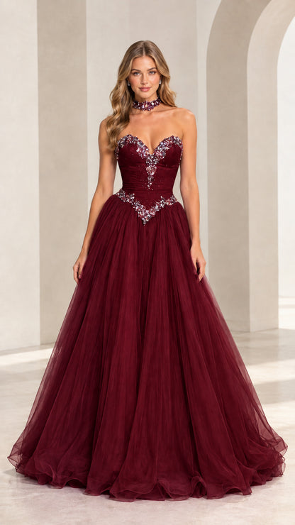 Model wearing burgundy strapless crystal embellished tulle gown