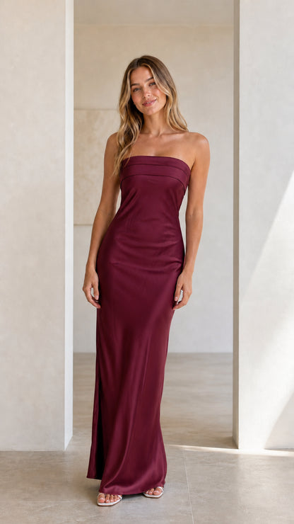 Front view of model wearing a burgundy wine strapless satin maxi dress
