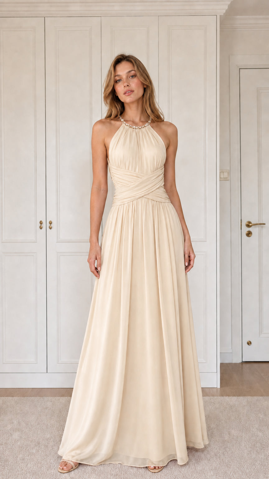 Front view of woman wearing champagne cream halter pleated chiffon maxi dress