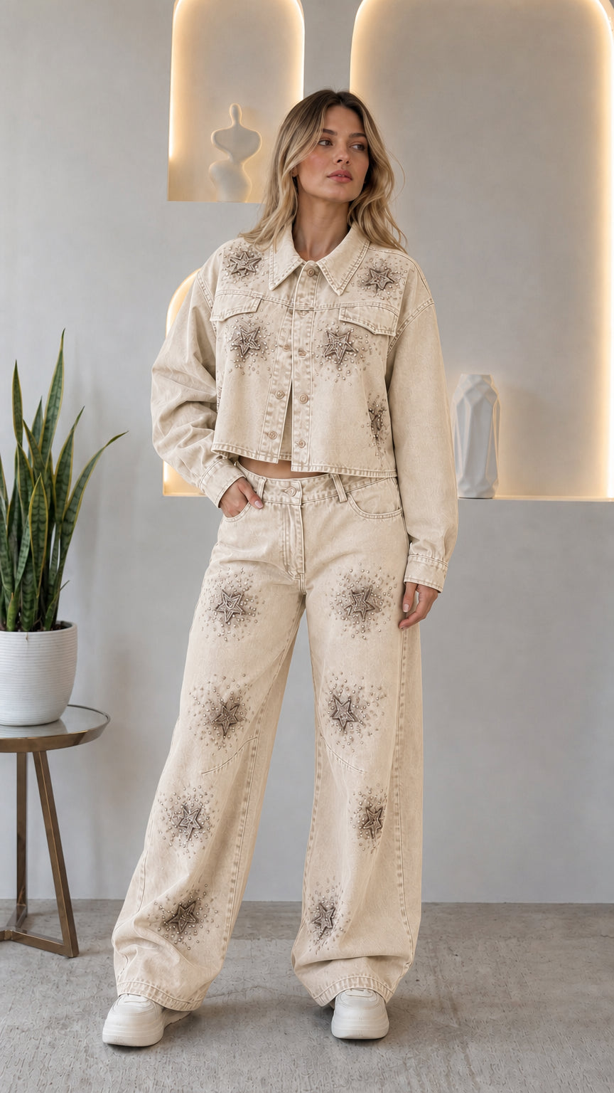 Woman wearing cream off-white rhinestone star cropped denim jacket and wide leg jeans two-piece set