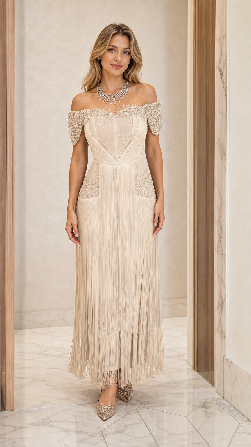 Front view of champagne cream off-the-shoulder fringe evening gown
