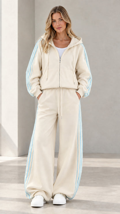 Model wearing cream beige two-piece tracksuit set with striped details