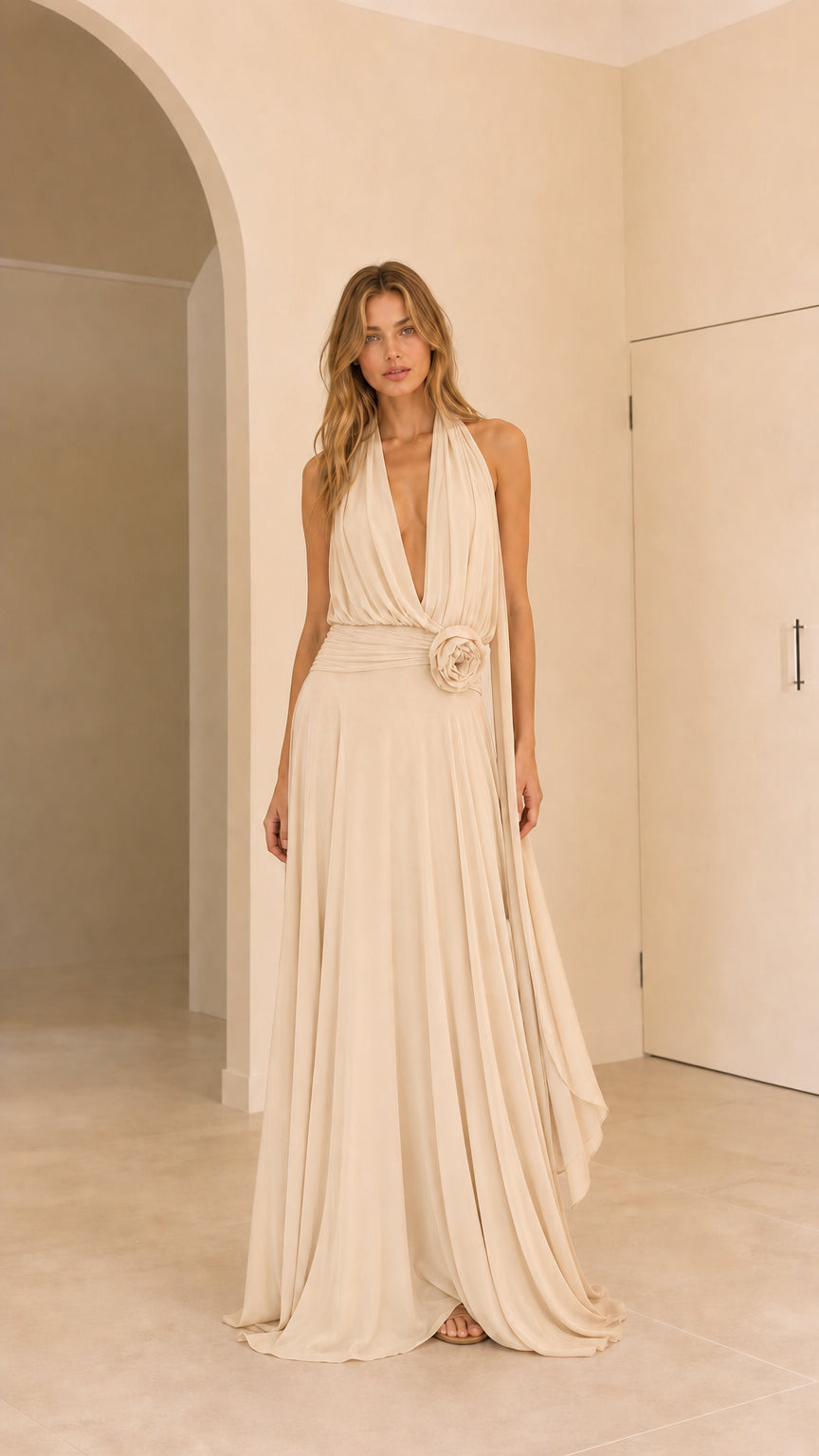 Full front view of champagne cream halter pleated maxi dress with rosette waist