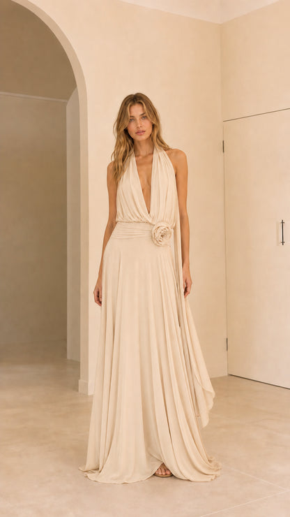 Full front view of champagne cream halter pleated maxi dress with rosette waist